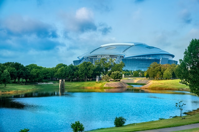 View of the AT&T Stadium with pond in front in Arlington, TX.