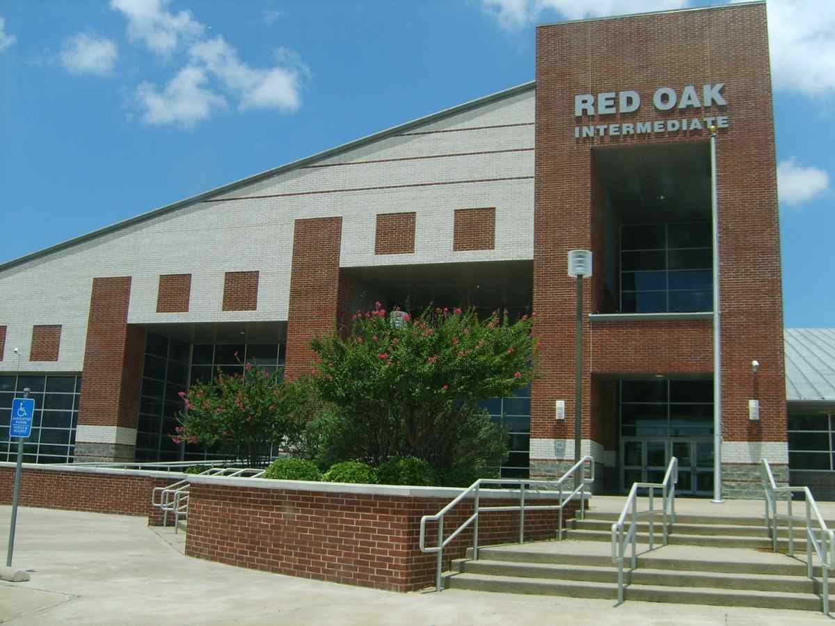 Red Oak Intermediate School - Triangle shaped building that is tall on the left and roof slants down to the right for article Red Oak Texas for newcomers moving to DFW or moving within Dallas-Fort Worth area.