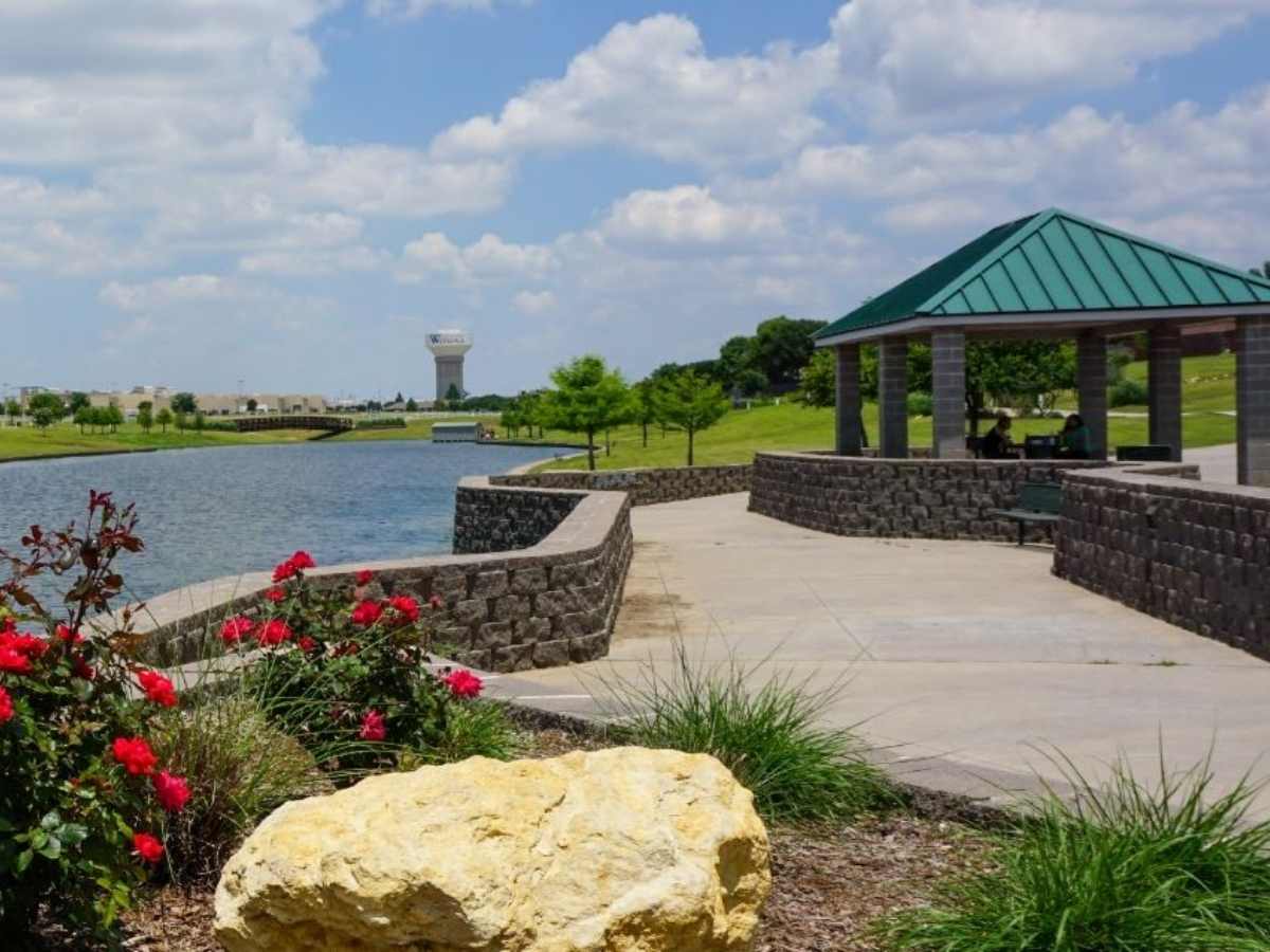 Park area with walkway and shelter overlooking water for article Watauga Texas for newcomers moving to DFW or moving within Dallas-Fort Worth area.