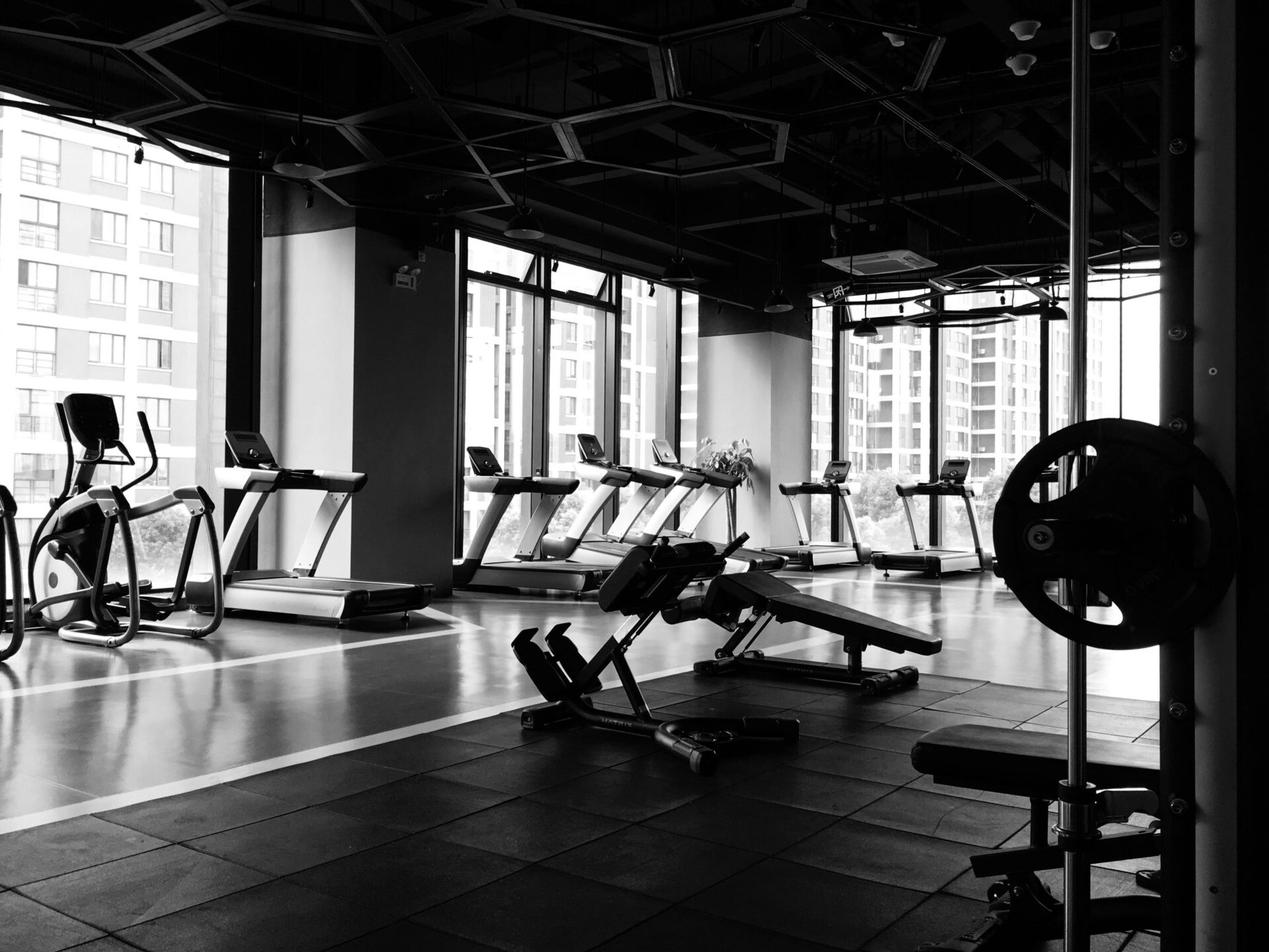 black and white photo of gym equipment setup indoors