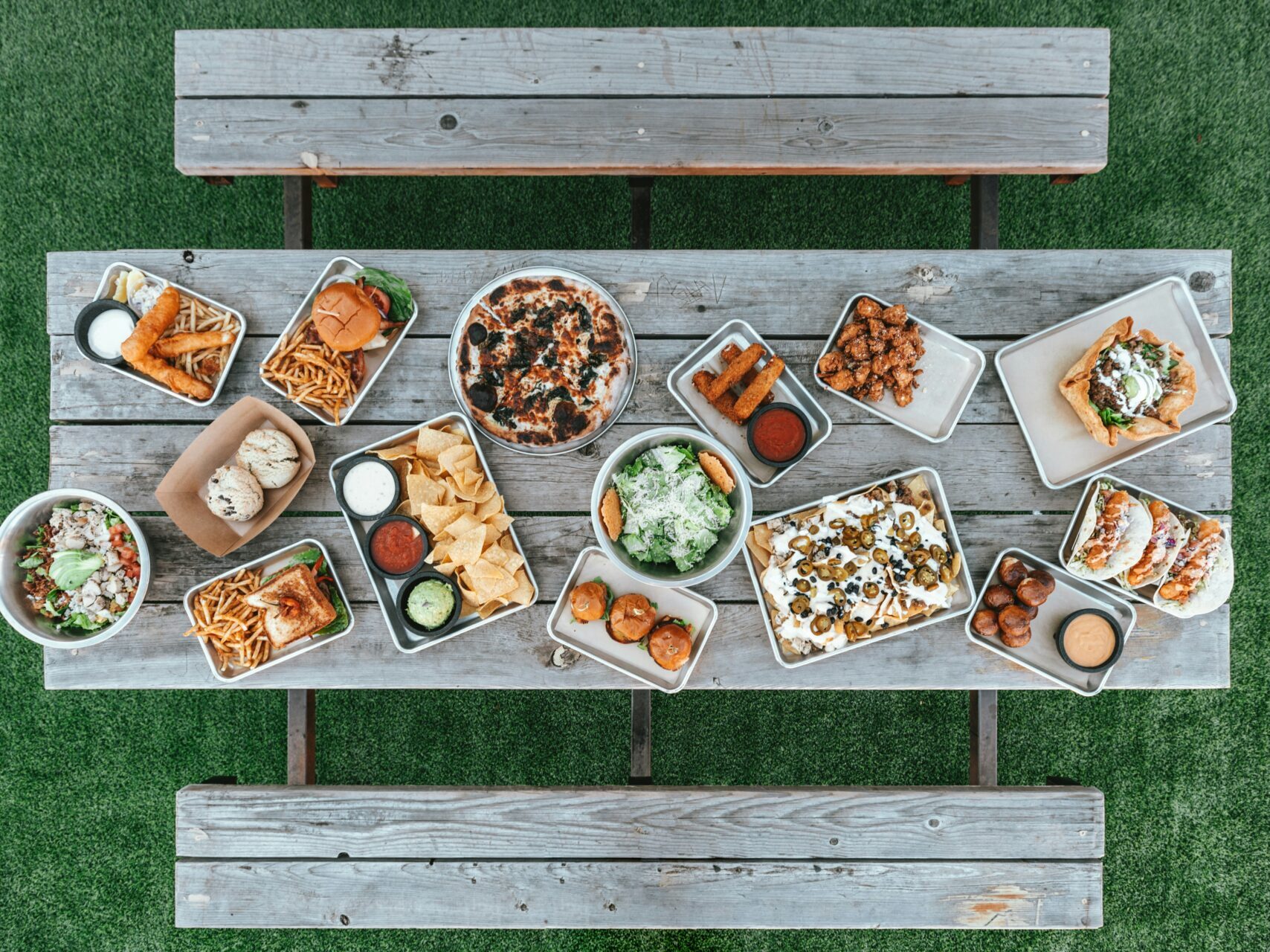 an aerial view of a variety of food on a picnic table