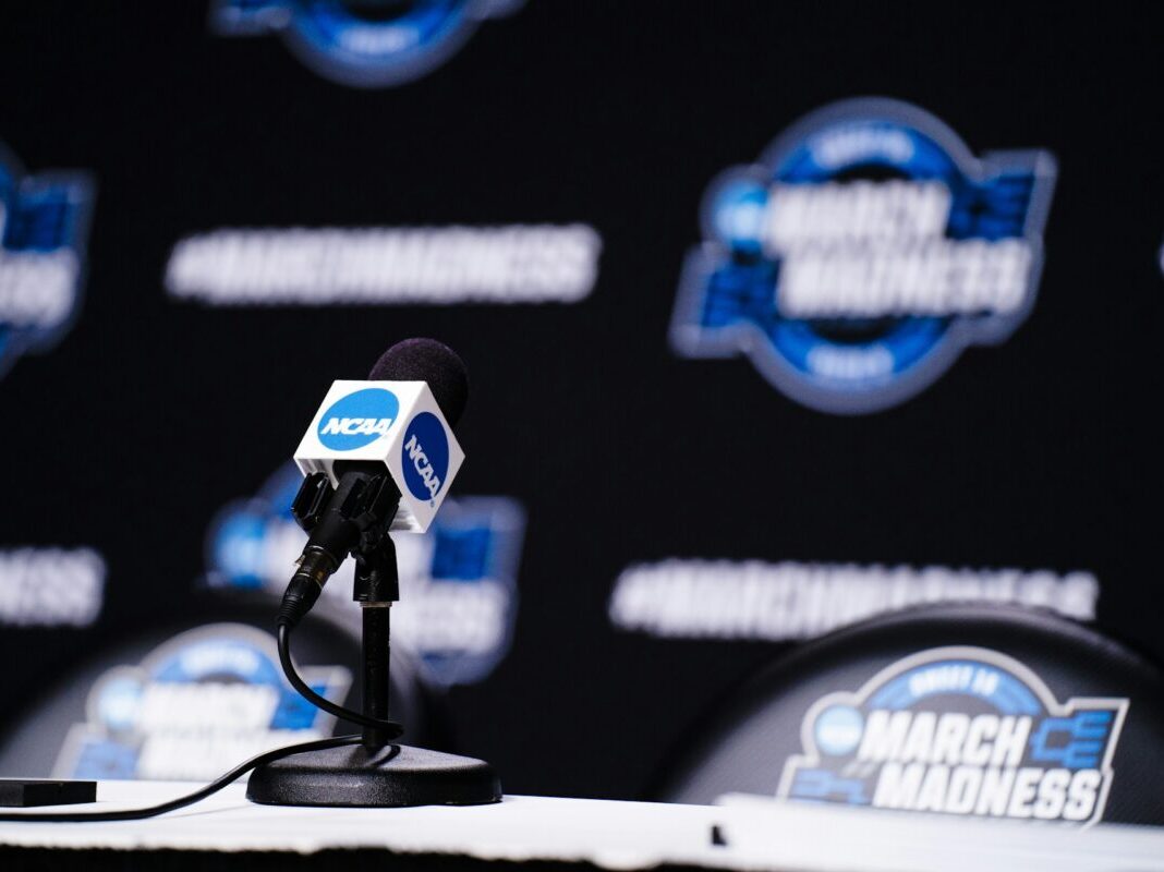 NCAA press mic with March Madness background