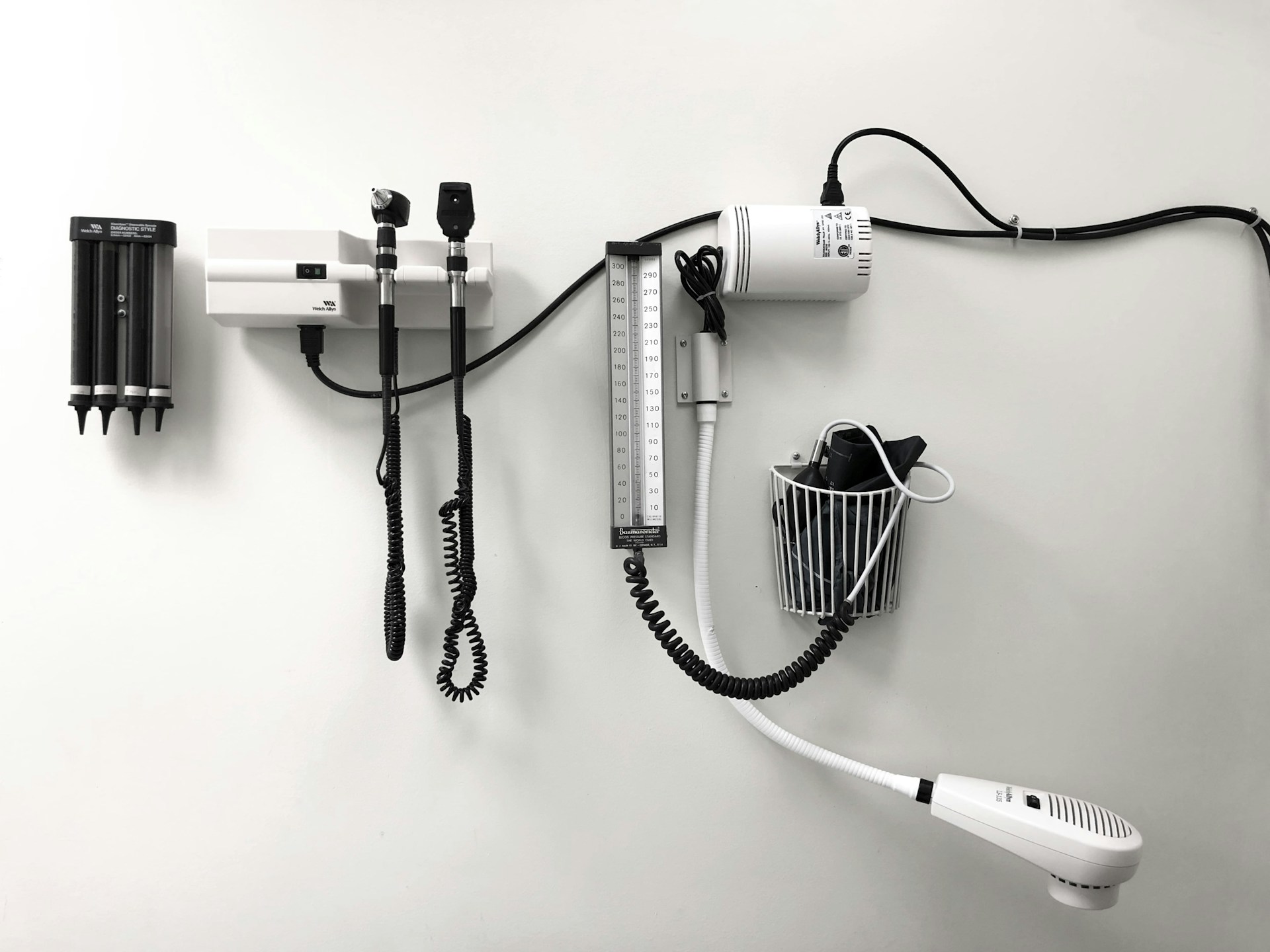 white wall with hanging medical instruments