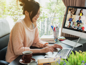 Woman working from home computer on a virtual work team call