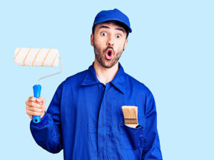 Man holding paint roller with whoops look on his face for article 7 Costly Painting Mistakes to Avoid.