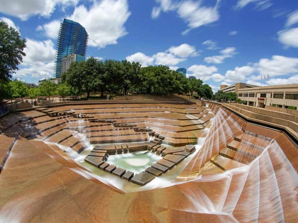 Picture of the Fort Worth Water Gardens with steps and water going down to pool in the center for article Experience the Arts and Culture in Dallas Fort Worth for newcomers moving to DFW.