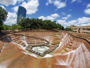 Picture of the Fort Worth Water Gardens with steps and water going down to pool in the center for article Experience the Arts and Culture in Dallas Fort Worth for newcomers moving to DFW.