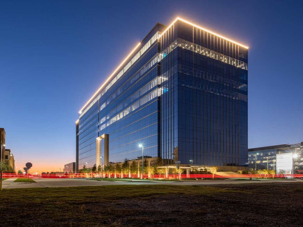 Keurig Dr. Pepper headquarters at dusk for article 15 Corporate Headquarters Located in DFW for newcomers moving to DFW.