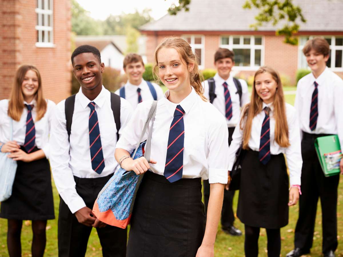 High school students wearing private school uniforms outside of school for article Largest Private High Schools in DFW for newcomers moving to DFW.