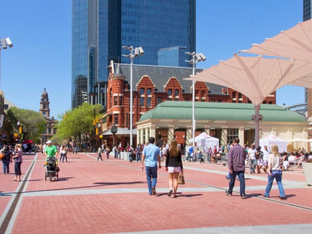 People walking in Sundance Square in downtown Fort Worth for article Walkable Neighborhoods in Dallas-Fort Worth for newcomers moving to DFW or moving within the Dallas-Forth Worth area.
